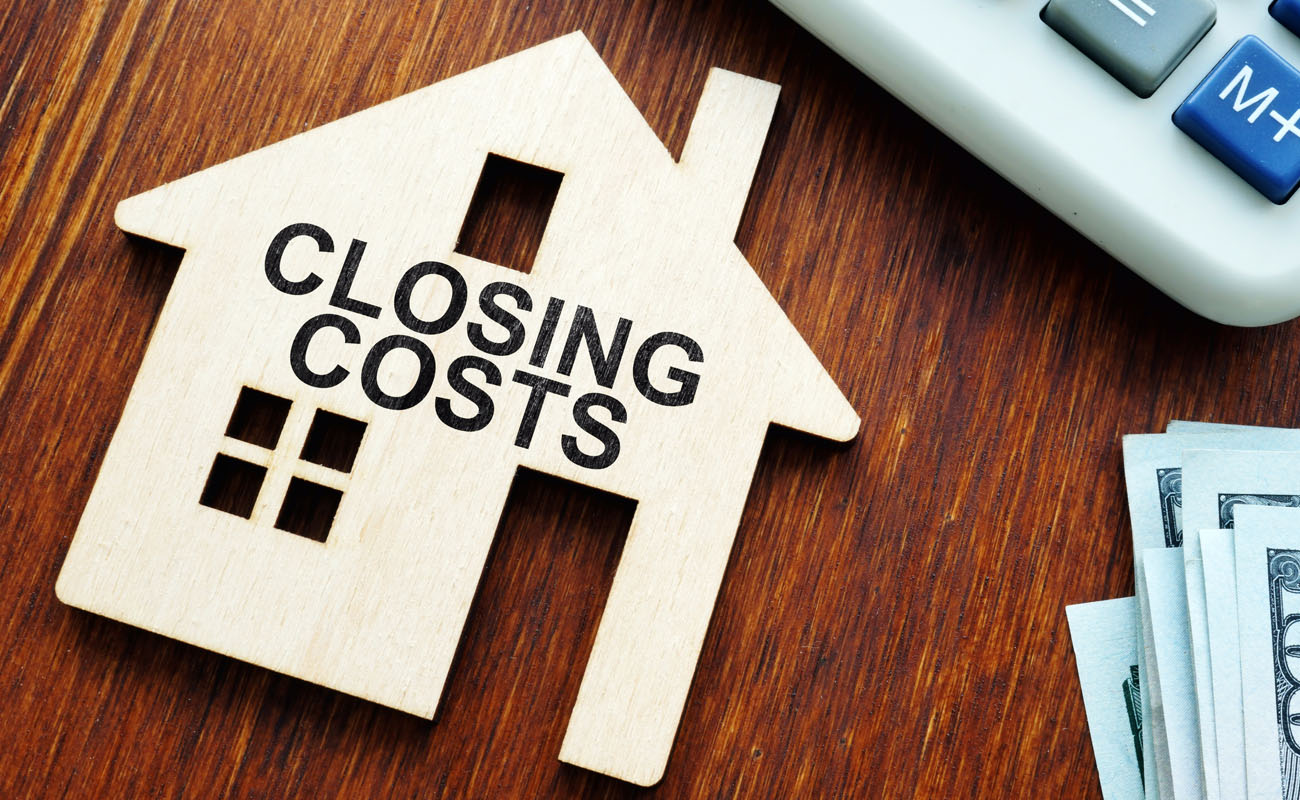 House model with closing costs sign.