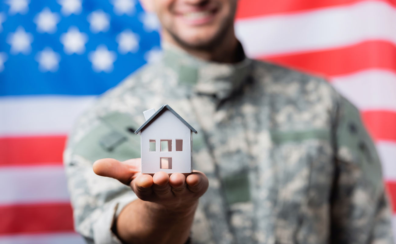 Soldier holding a house model.